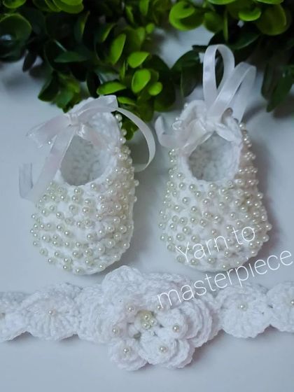 A classic choice for a special occasion like a baptism or naming ceremony. This set includes a pair of pure white crochet booties covered in hand-sewn pearls and a matching floral headband.