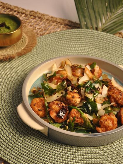 A close-up of my Prawn 65, another coastal specialty. The prawns are crispy from the rawa fry technique and tossed with fragrant curry leaves, garlic, and chilies, making for an irresistible seafood appetizer.