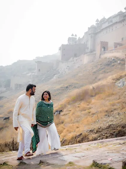 A candid moment of walking and talking against the historic backdrop of Amer Fort. The natural interaction and the stunning scenery combine to create a beautiful, authentic pre-wedding photograph.