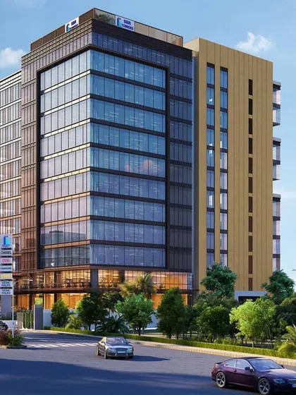 Another perspective of the Sarjapur Road commercial property, highlighting its corner location and dual-material facade design.