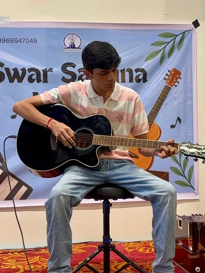A teen guitarist focused and in the zone during his stage performance. We prepare our students not just with technical skills but also with the stage presence to perform confidently.