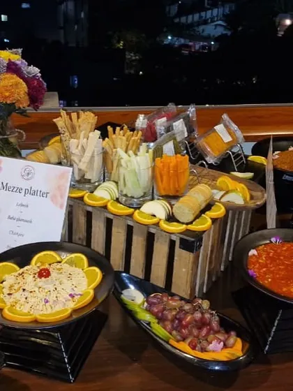 A cozy Mezze corner at one of our events, featuring a variety of dips, salads, and breads for guests to enjoy.