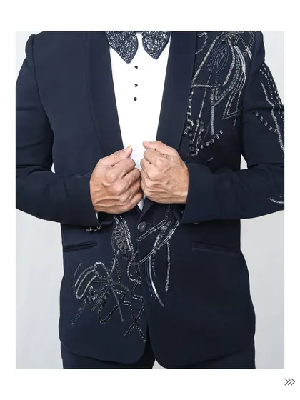 A full torso shot of the embellished navy tuxedo. The detailed beadwork flows down the lapels, creating a visually stunning effect that's perfect for photos.