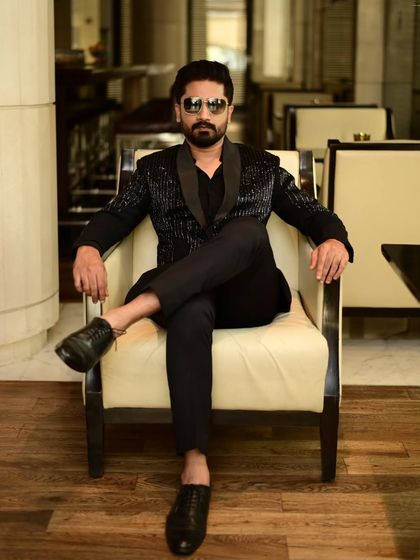 A client exuding confidence in our black sequin blazer. This is modern menswear at its finest.