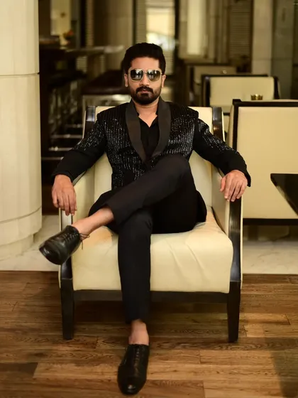 A client exuding confidence in our black sequin blazer. This is modern menswear at its finest.