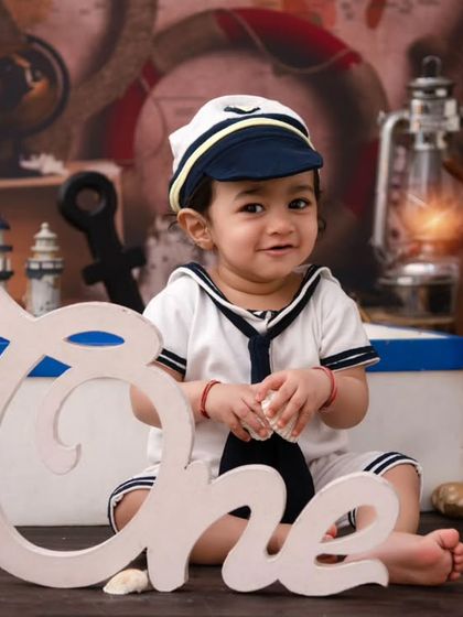 Celebrating one with a nautical twist. The 'One' sign fits perfectly into this adventurous sea-themed first birthday setup.