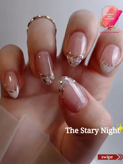 We call this one 'The Starry Night'. It's an elegant design featuring a modern French tip with a delicate line of crushed crystals and a fine gold wire accent.