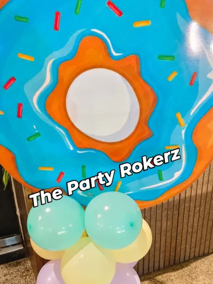 A giant donut prop on a balloon base, part of the Candyland theme. These large props are great for photos and making the theme feel larger than life.