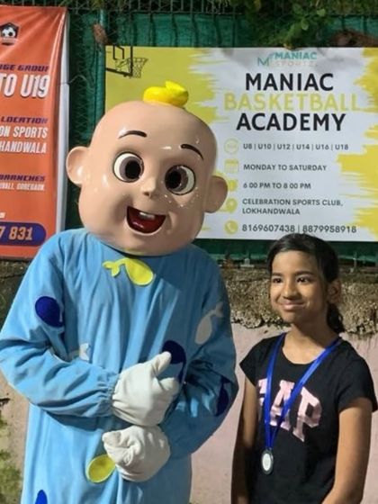 A young player poses with the mascot at "The Carnival." We create a fun and festive atmosphere for the whole family.