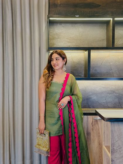 The complete look, styled with a gold clutch that complements the festive vibe. This outfit proves that a well-chosen color combination can make a powerful style statement.