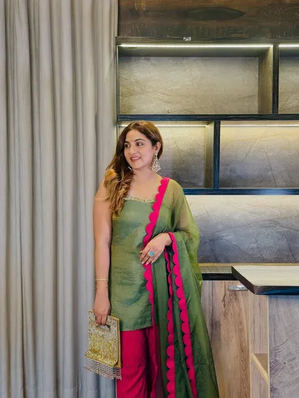 The complete look, styled with a gold clutch that complements the festive vibe. This outfit proves that a well-chosen color combination can make a powerful style statement.