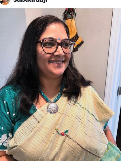A happy client wearing her custom-embroidered saree. Her smile is a testament to the joy that handmade items can bring.