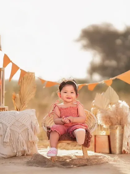An outdoor boho-themed shoot for a toddler. I can set up beautiful, stylized scenes in natural settings, complete with props like a teepee and macrame details.