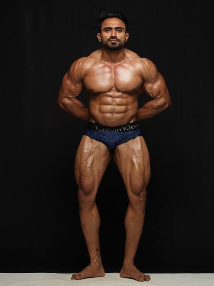 Another shot from my photoshoot. The front relaxed pose, displaying the V-taper and full chest.