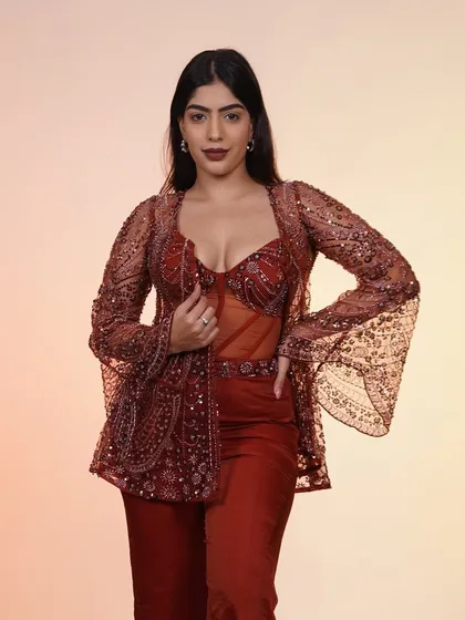 A full-length shot of the rust-colored Indo-Western outfit, showing off its unique silhouette and rich color.