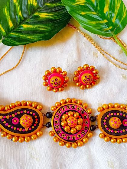 This version of the paisley and mandala choker is in a bright and cheerful pink, orange, and yellow.