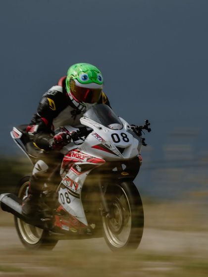 A rider in a unique frog-themed helmet, showing that our community is full of personality. We're all serious about riding, but we have fun doing it.