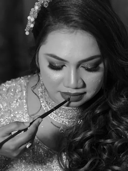 A black and white shot of me applying lipstick. It captures the focus and artistry involved in creating the perfect lip shape.