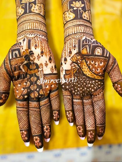 A close-up of the beautiful varmala portrait, with the bride and groom figures rendered in exquisite detail.