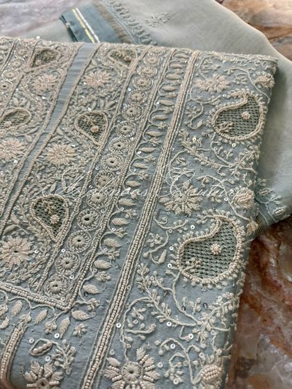 A macro shot of the embroidery, detailing the fine Chikankari stitches and sequin work.