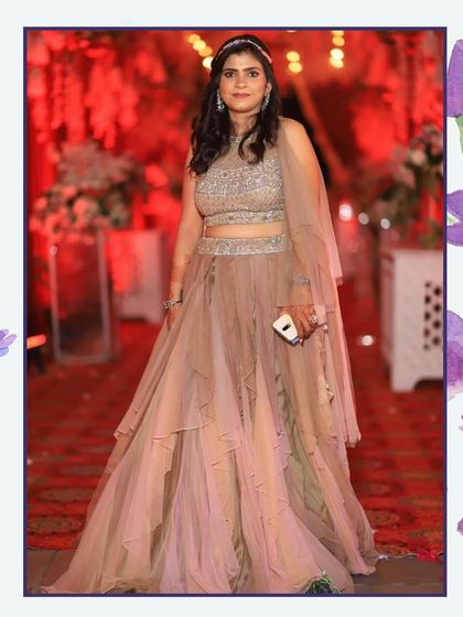Another look at the beautiful beige tiered lehenga, worn by a happy client. It's a versatile piece that works for many different evening celebrations.