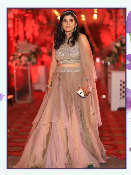 Another look at the beautiful beige tiered lehenga, worn by a happy client. It's a versatile piece that works for many different evening celebrations.