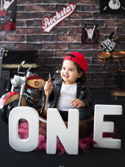 A cool little rockstar posing with the letters O-N-E for his first birthday.