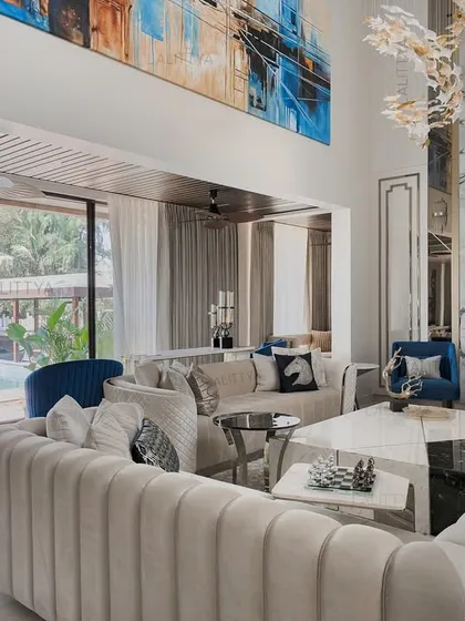 We designed this living area to open directly onto the pool deck, blurring the line between indoors and outdoors. The space is filled with natural light, and the layout uses symmetry and luxurious materials to create a warm, lived-in feel that is connected to its surroundings.