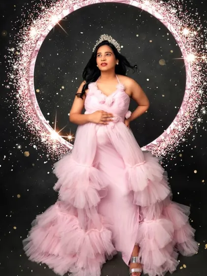 Feel like a princess in this pink ruffled gown, complete with a sparkling tiara and a glamorous, starry backdrop.