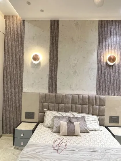 A close-up of the bed and headboard, highlighting the detailed paneling and the elegant wall sconces. This shot emphasizes our focus on creating beautiful and functional design details.