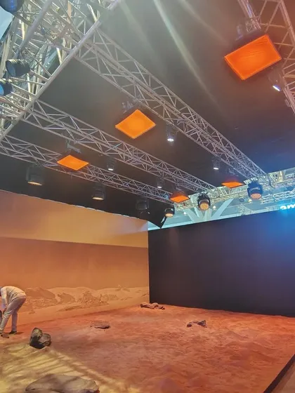 Our crew at work setting up the lighting and stage for the WAVES 2025 exhibition. The overhead truss is packed with various lighting fixtures to demonstrate our integrated lighting capabilities.