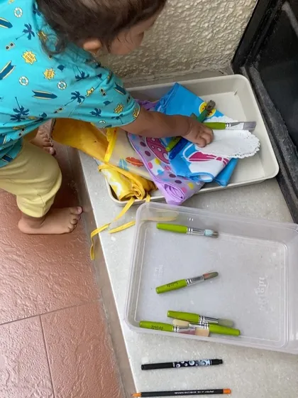Another shot of our little helper cleaning up. These simple routines build good habits and teach children that taking care of their materials is part of the activity itself.