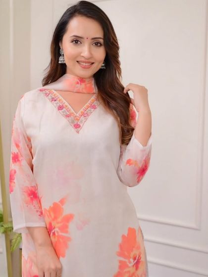 This off-white premium organza kurta has a beautiful watercolor floral print. It's a soft, feminine, and elegant piece for any special occasion.