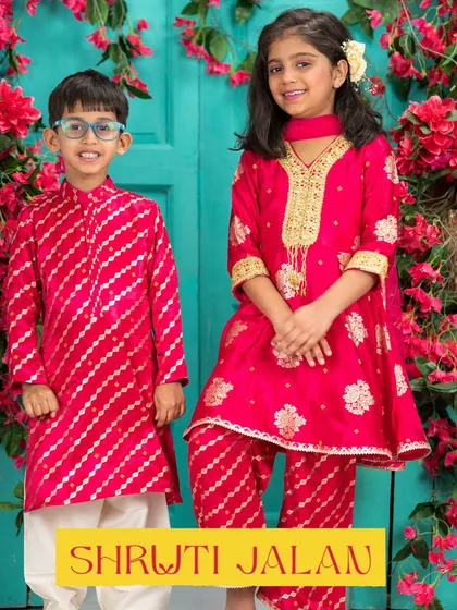 A vibrant Rakhi look with this brother and sister in a striking red. His striped kurta and her embroidered suit are designed to make a statement.