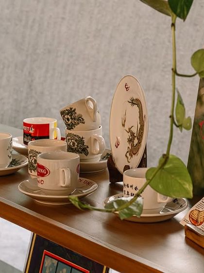 These shelves are filled with little pieces of my past. You can see the traditional Kopi cups, old vinyl records, and other vintage items that I collected. Each one reminds me of the coffee shops I visited as a child in Malaysia.