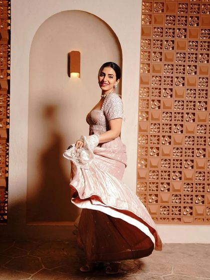 A full-length shot of a celebrity client in a beautiful dusty rose gown. The makeup is elegant and sophisticated, perfect for a red carpet or high-profile event.