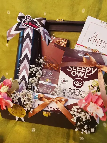 A perfect coffee-themed hamper for your brother this Rakshabandhan. It includes Sleepy Owl coffee, a stylish sipper, and assorted chocolates, all arranged in a rustic wooden tray.