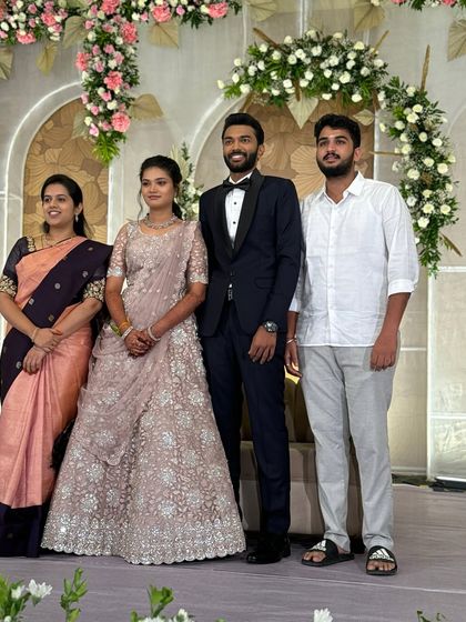 My beautiful bride Ragavi with her family at her reception. She looks effortlessly chic in a pastel lehenga, with her glam makeup and soft hairstyle completing the modern look.