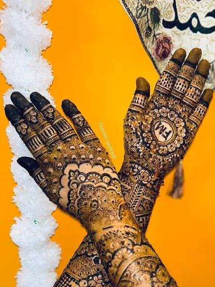 A lovely crossed-hands pose showing the intricate details on the palms. The design is dense and full of traditional motifs.