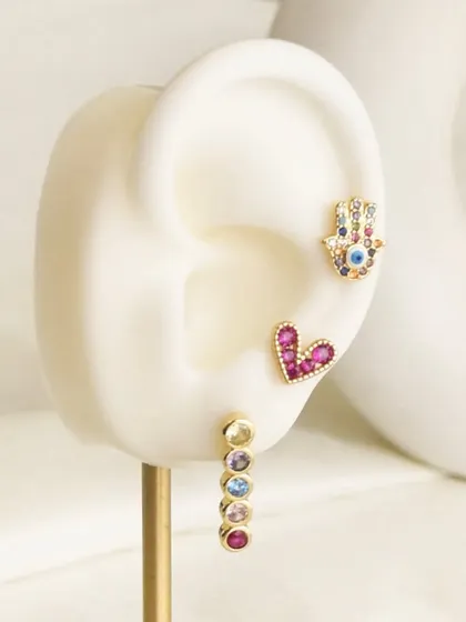 A close-up of the Multi Rosie Hamsa earring set. I love the combination of the hamsa, heart, and gemstone studs.
