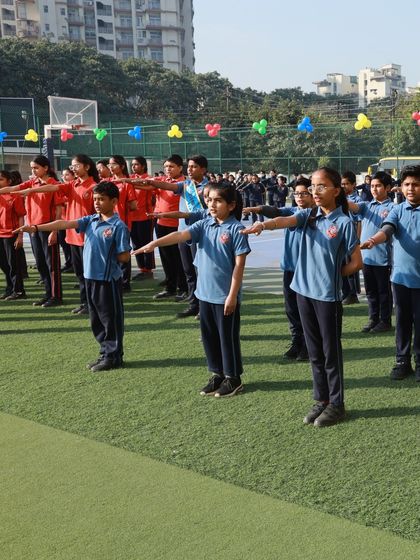 Students stand in formation, taking an oath of sportsmanship during the Annual Sports Day. We emphasize the values of fair play, respect, and integrity in all our sporting events.