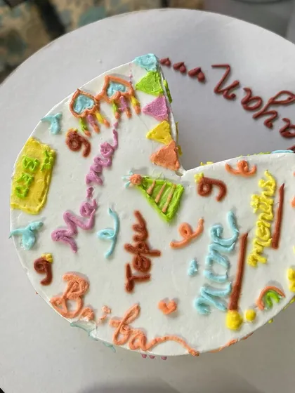 Your story, your cake. This unique doodle cake is covered in little illustrations that represent Mayan's favourite things from his first nine months. We love creating these personal, story-telling chocolate truffle cakes.