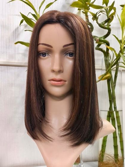 A studio shot of our Silk Base 5x7 Topper on a mannequin, showcasing its sleek style and natural appearance against a clean background.
