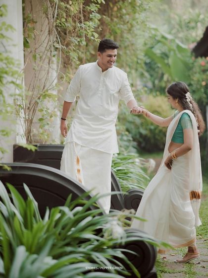 A playful moment of the couple dancing in a garden, their movements full of grace and joy.