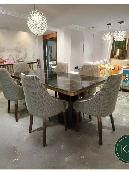 This dining set pairs a dark, glossy rectangular table with six comfortable, upholstered chairs. The modern chandeliers add a touch of glamour, making this a perfect space for both family meals and dinner parties.