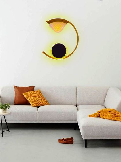 This crescent-shaped wall light with a warm, backlit glow adds a touch of artistic elegance to a living room. It's a perfect example of lighting that redefines luxury by doubling as decor.