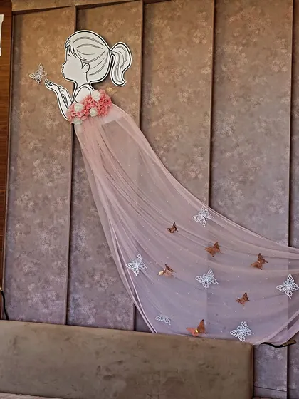 A closer look at the whimsical wall decor for Miraya's welcome. The illustration of a girl with a flowing tulle dress decorated with butterflies is a unique and artistic touch.
