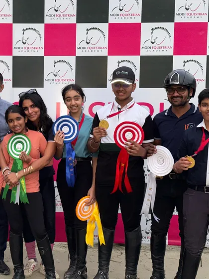 A large group of our riders, coaches, and family celebrating a successful competition. The VEA community is a family that supports each other's dreams.
