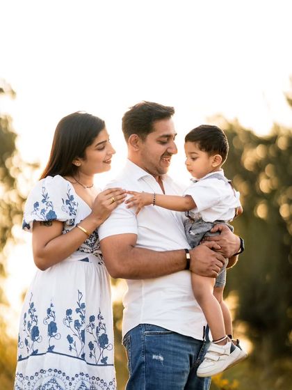 A classic family portrait taken outdoors with beautiful backlighting. Even in a posed shot, I focus on capturing the connection between family members.
