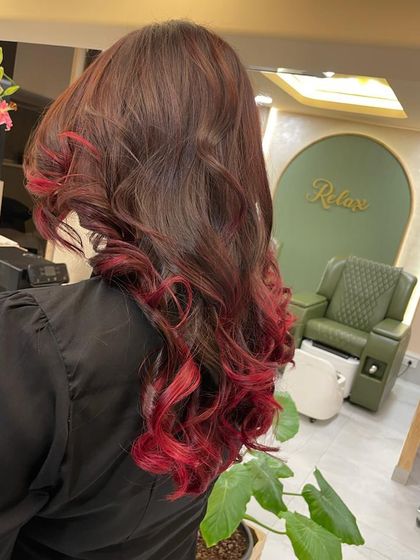 The view from the "Relax" corner, showing off the vibrant red tips that add a pop of colour to her long, dark hair.